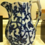 White china jug with pattern of blue vines and leaves.